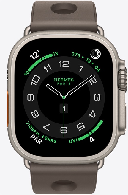 Apple Watch Hermès Ultra 3, titanium case, natural color, Hermès Circulaire watch face, complications: weather, activity rings, PAR, UV index, right side exterior, Digital Crown, microphone, raised side button, Scub'H Diving band, gris titane color