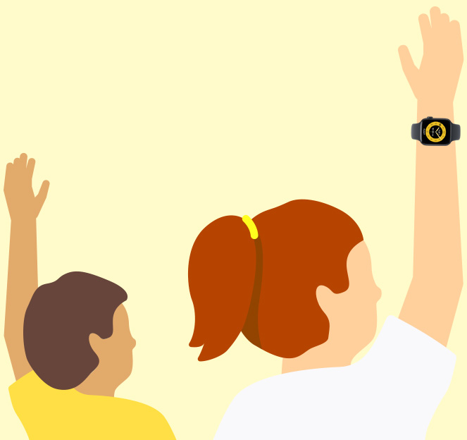 Barn som räcker upp handen i ett klassrum. De har Apple Watch-enheter på sig.