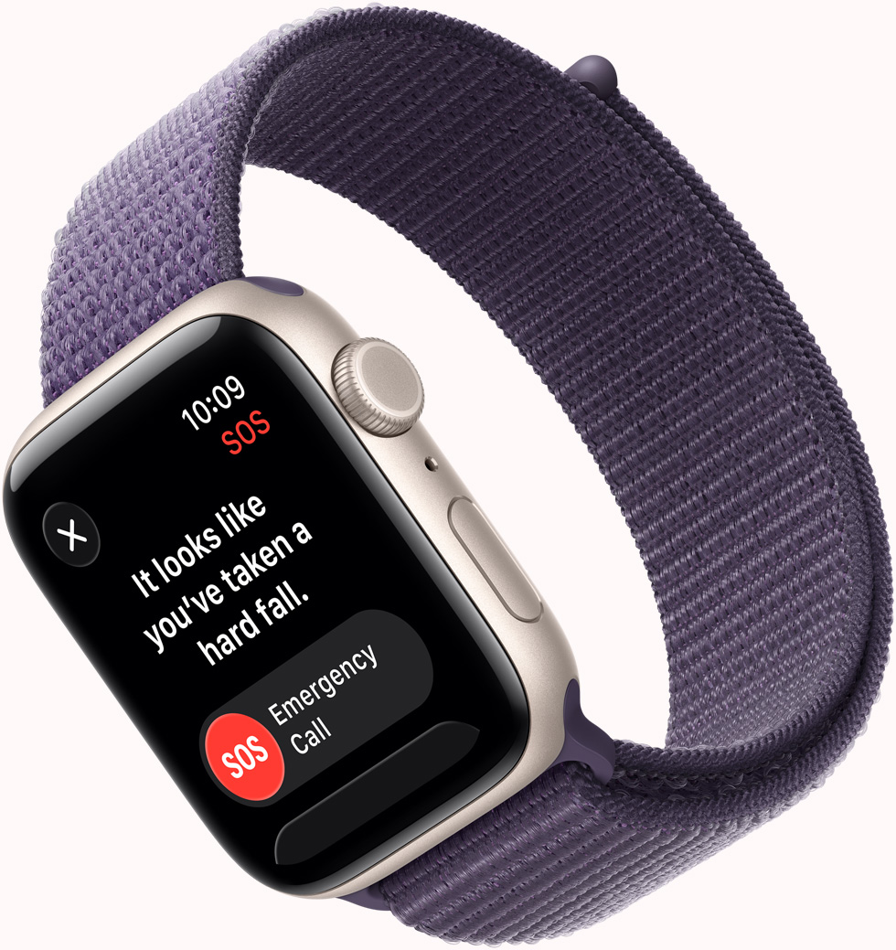 Apple Watch SE 3，採用星光色鋁金屬錶殼，展示 SOS 跌倒偵測通知、緊急電話及「我沒有大礙」按鈕，機身右側設有數碼錶冠、咪高風、側邊按鈕，配搭霧紫色運動手環