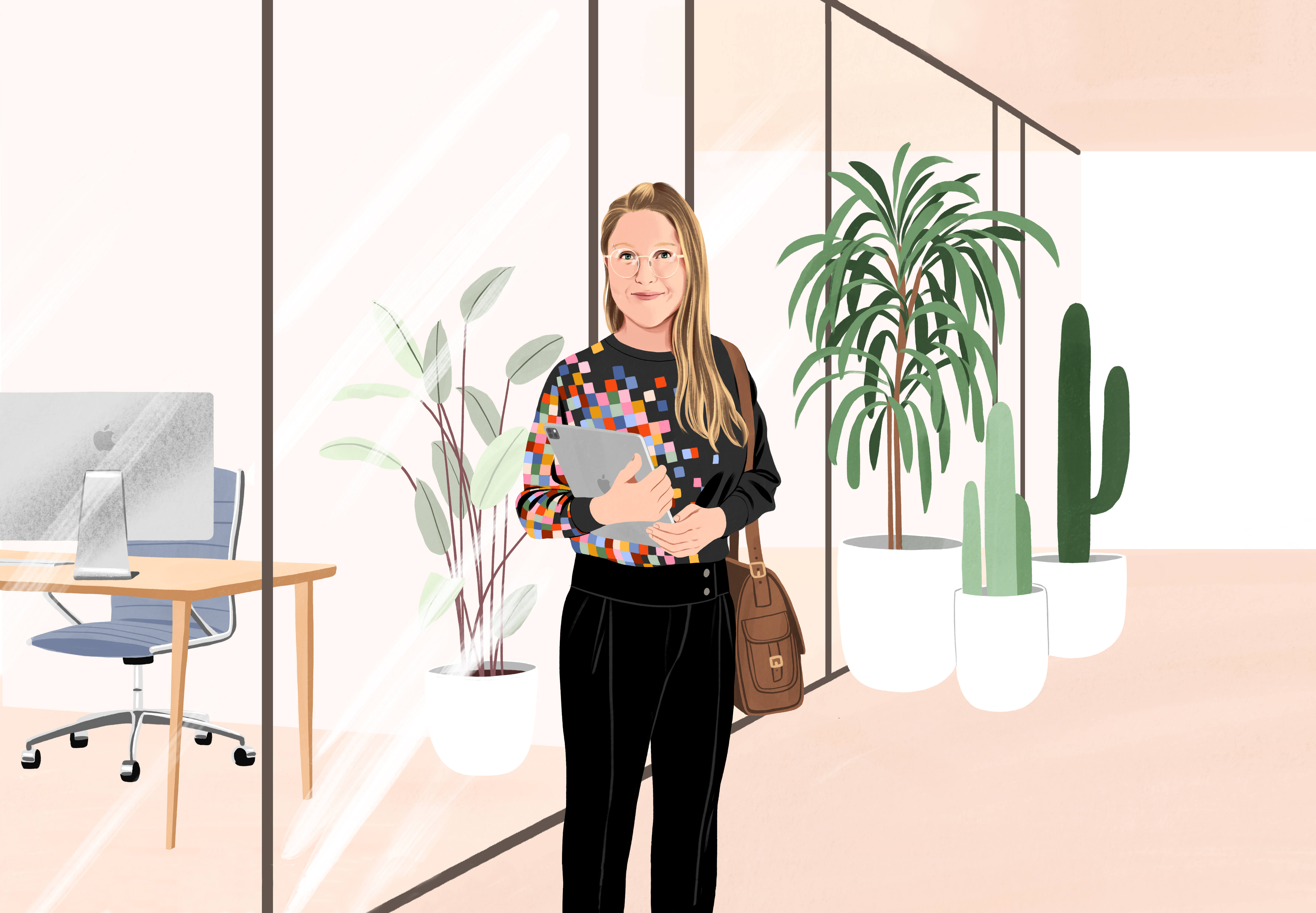 Manuela, le sourire aux lèvres, se trouve dans un couloir de bureau avec un iPad dans les mains et une sacoche à l’épaule. Elle porte un pantalon noir et un chandail noir orné d’un motif de pixels colorés sur le côté.
