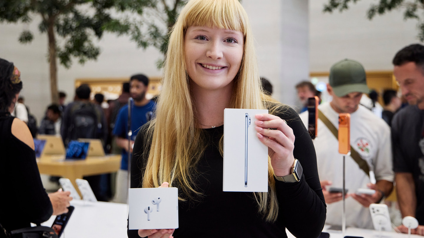 A customer shows off her new sky blue iPhone Air and AirPods Pro 3 at Apple Regent Street in London.